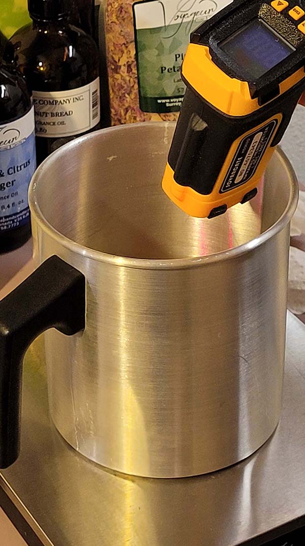 picture of testing temperature of soy wax during candle making process