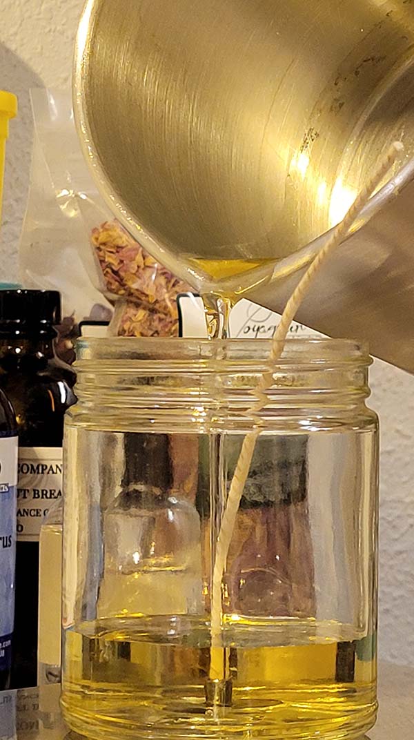 picture of pouring melted soy wax into candle jar
